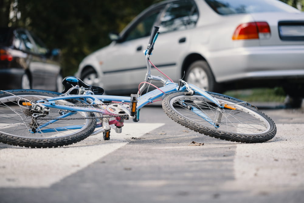 Bicycle lying on roadway after collision with a car during a traffic accident